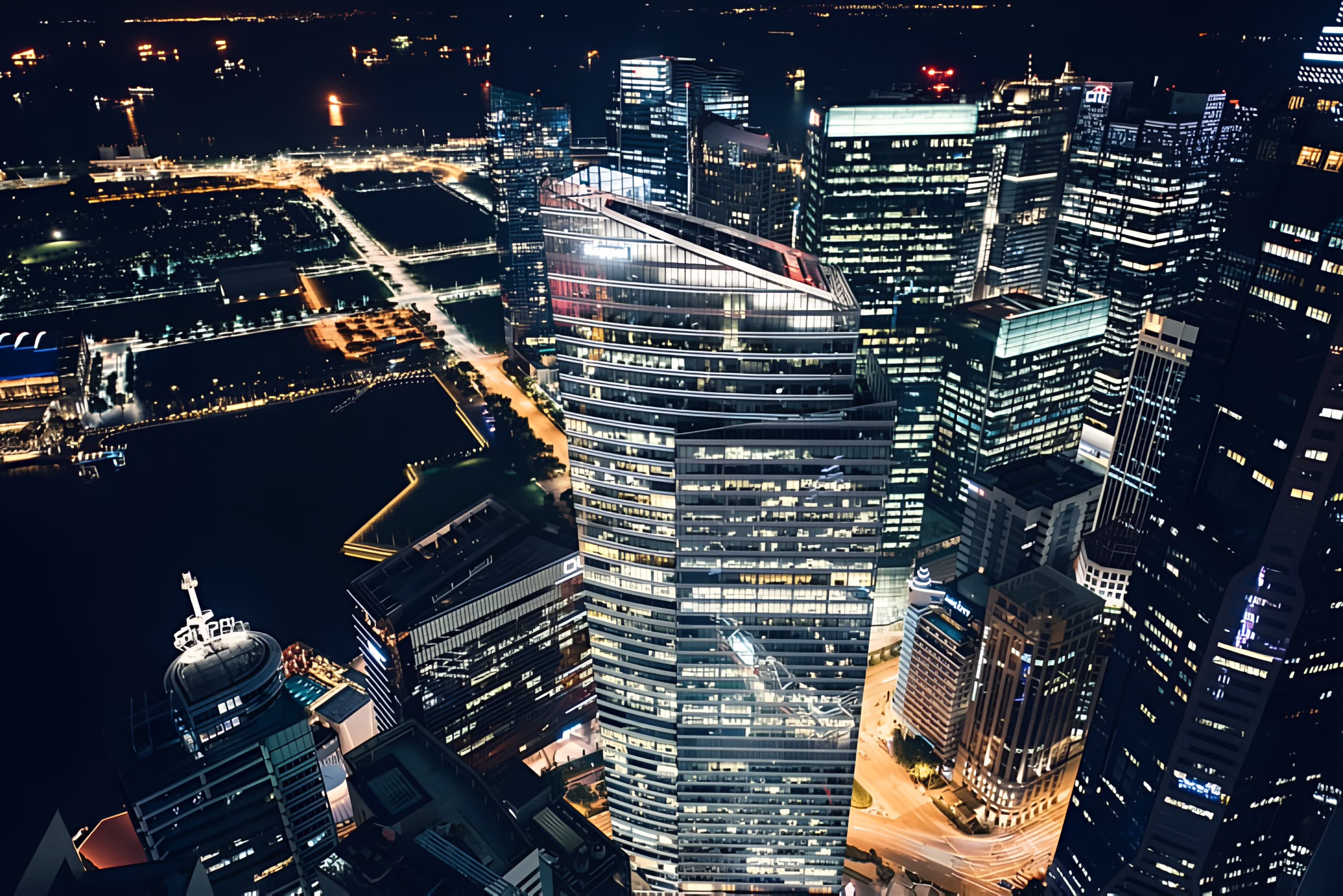 Aerial view of illuminated city towers at night