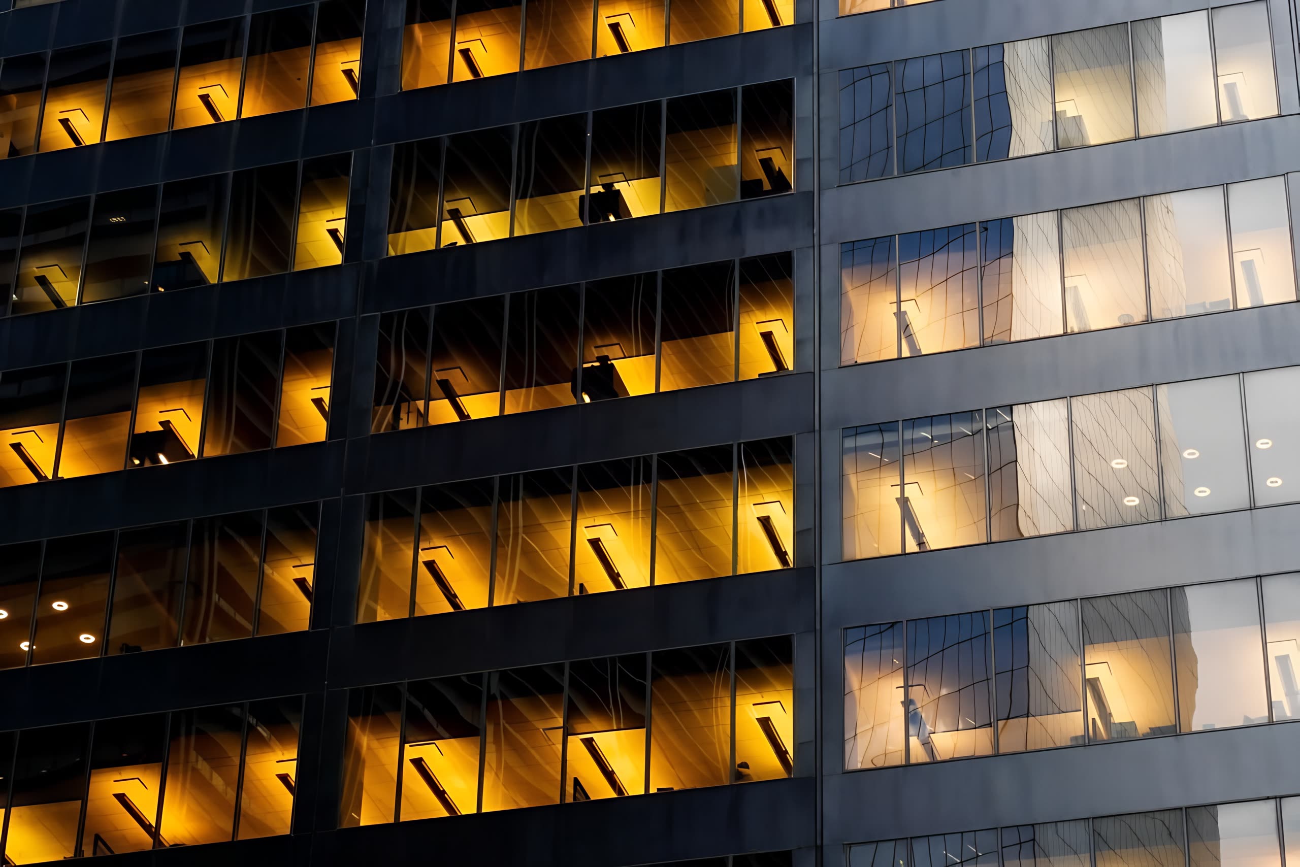 Geometric glass tower facade at night